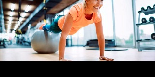 Woman planking with stress ball